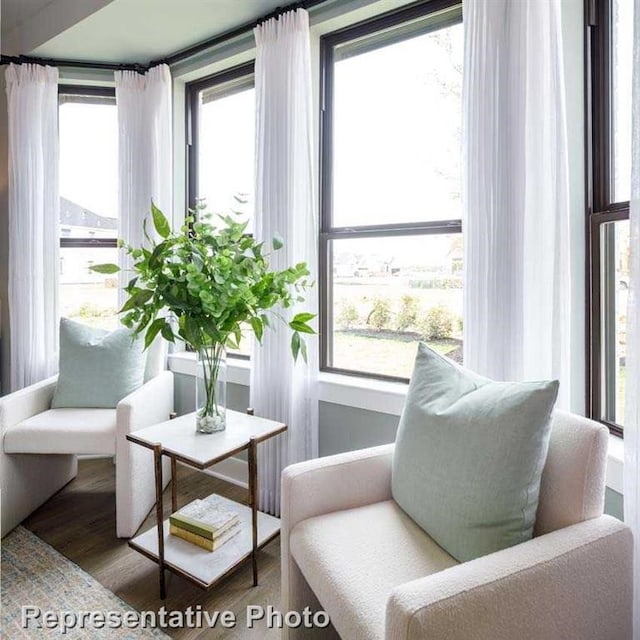 sitting room with wood finished floors and a wealth of natural light