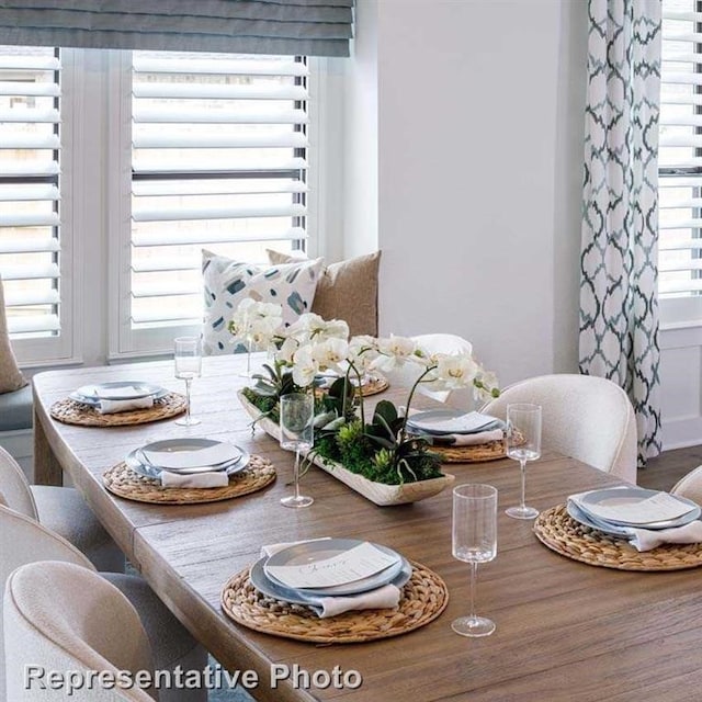 dining space with wood finished floors