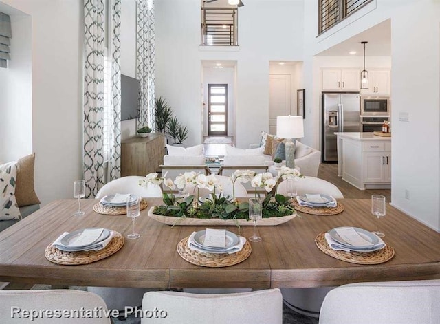 dining room with a towering ceiling