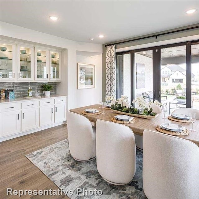 dining space with light wood-type flooring, plenty of natural light, and recessed lighting