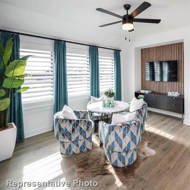 dining area with wood finished floors, baseboards, and ceiling fan
