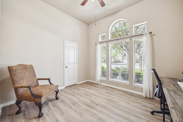 6315 Teal Mist Ln, Fulshear, TX 77441 - home office featuring light wood-style floors, baseboards, a ceiling fan, and a towering ceiling