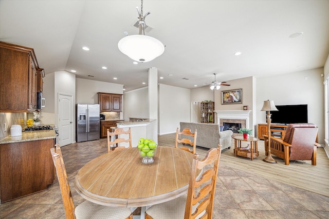 6315 Teal Mist Ln, Fulshear, TX 77441 - dining space featuring baseboards, a fireplace, a ceiling fan, and recessed lighting