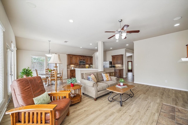 6315 Teal Mist Ln, Fulshear, TX 77441 - living area with light wood finished floors, a ceiling fan, baseboards, lofted ceiling, and visible vents