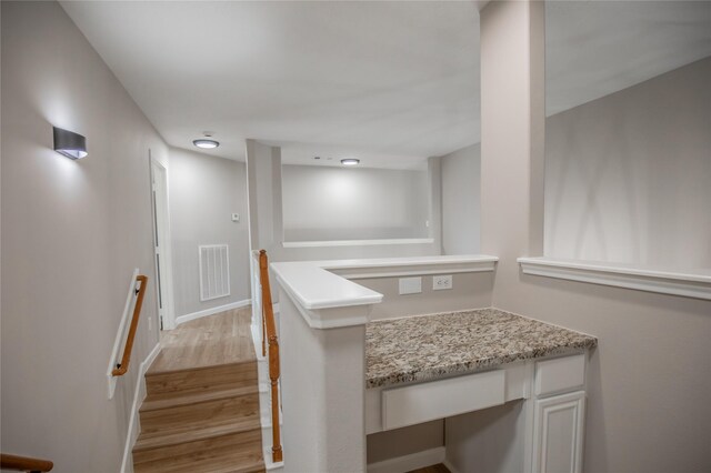 interior space with wood finished floors, visible vents, and baseboards