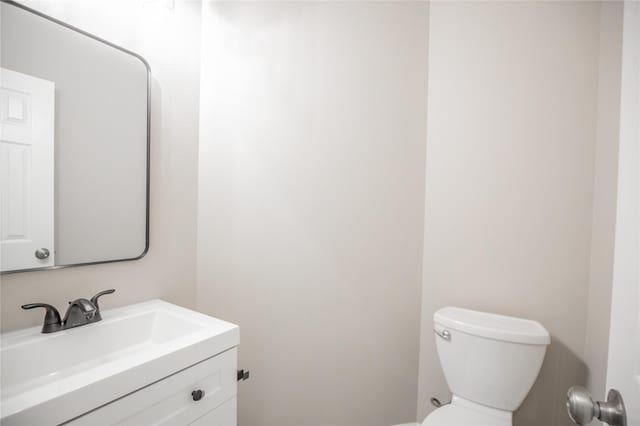 bathroom featuring toilet and vanity