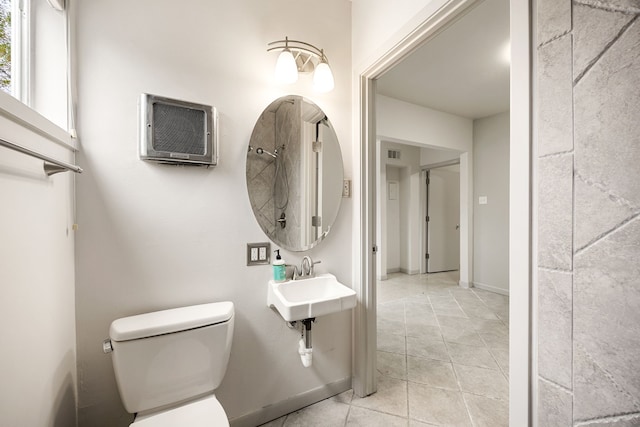 bathroom featuring a wall mounted air conditioner, a sink, toilet, tile patterned flooring, and visible vents