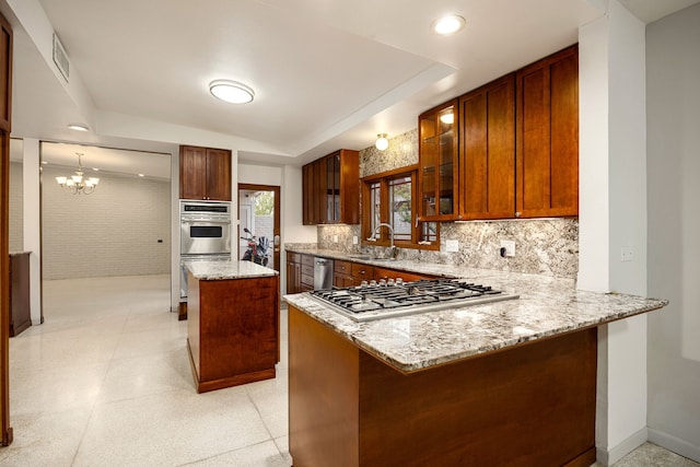 3622 N Braeswood Blvd, Houston, TX 77025 - kitchen featuring a sink, stainless steel appliances, light stone counters, glass insert cabinets, and a peninsula