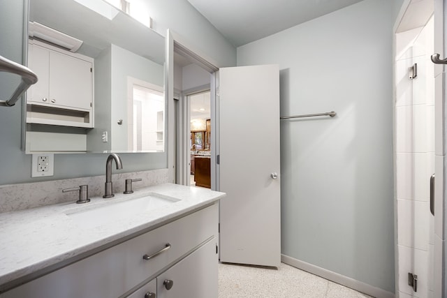 3622 N Braeswood Blvd, Houston, TX 77025 - bathroom with baseboards, vanity, and speckle patterned floor