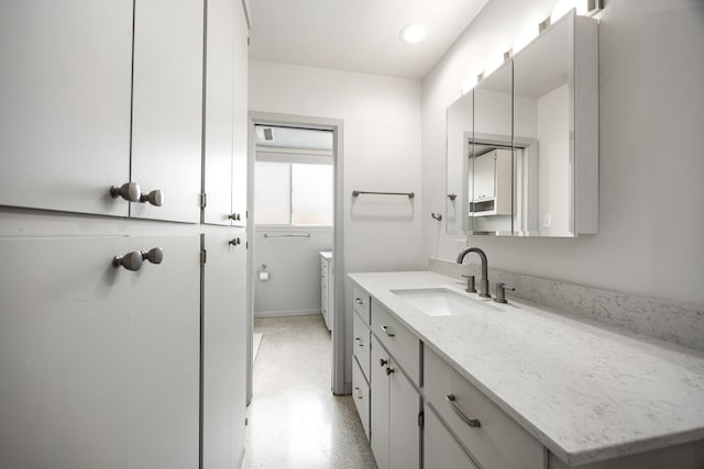 bathroom with recessed lighting and vanity