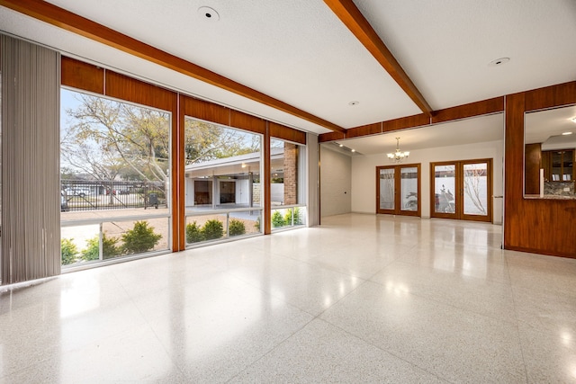 3622 N Braeswood Blvd, Houston, TX 77025 - unfurnished room featuring speckled floor, a chandelier, and beamed ceiling