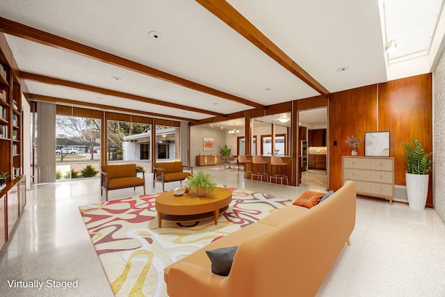 3622 N Braeswood Blvd, Houston, TX 77025 - living room with beamed ceiling, speckle patterned floor, and wood walls