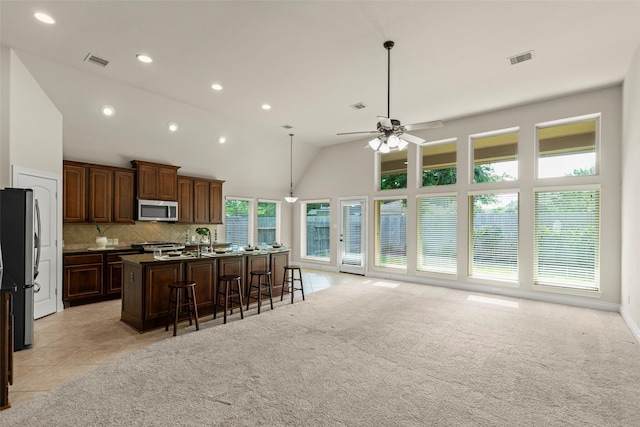 1846 Majestic Falls Ln, Richmond, TX 77469 - kitchen featuring recessed lighting, a kitchen breakfast bar, stainless steel appliances, visible vents, and open floor plan