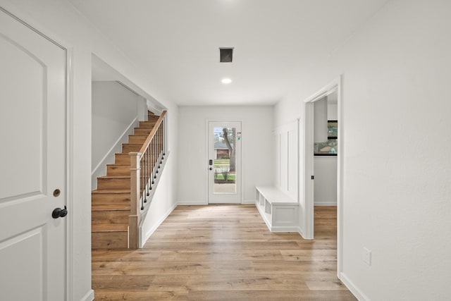 entrance foyer featuring light wood-style floors, stairs, baseboards, and recessed lighting