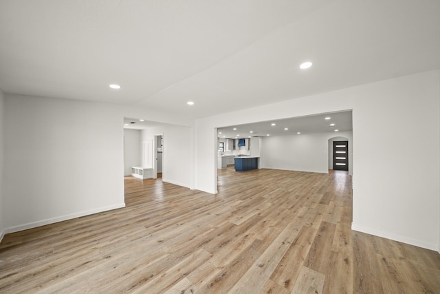 unfurnished living room featuring recessed lighting, light wood-style floors, and baseboards