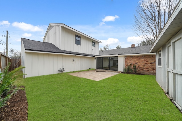 back of house featuring a patio area, brick siding, and a shingled roof