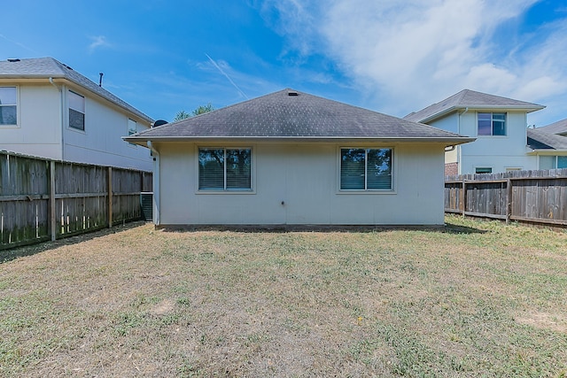 6626 Rusty Ridge Ln, Katy, TX 77449 - rear view of property with a fenced backyard, roof with shingles, and a yard