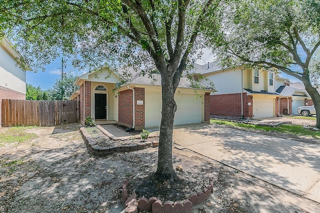 6626 Rusty Ridge Ln, Katy, TX 77449 - view of front of home featuring concrete driveway, brick siding, fence, and a garage