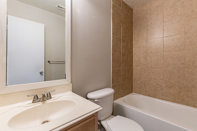 6626 Rusty Ridge Ln, Katy, TX 77449 - bathroom featuring toilet, visible vents, a textured wall, vanity, and tub / shower combination