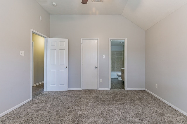 6626 Rusty Ridge Ln, Katy, TX 77449 - unfurnished bedroom with ensuite bathroom, baseboards, lofted ceiling, carpet flooring, and visible vents