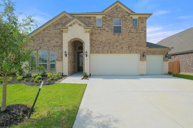 view of front facade with concrete driveway, a front lawn, an attached garage, fence, and brick siding