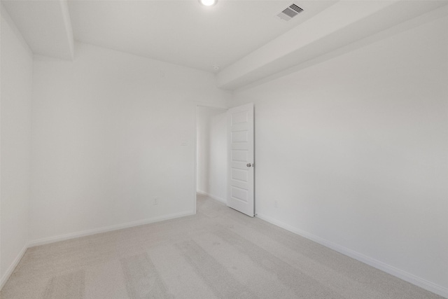 empty room with recessed lighting, baseboards, visible vents, and light colored carpet