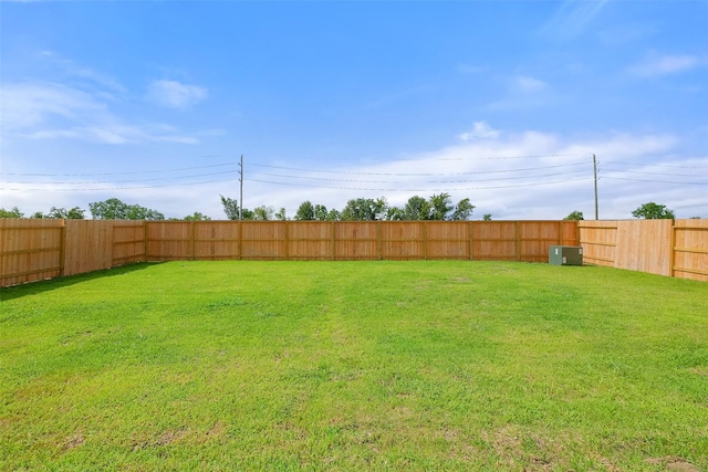 view of yard featuring a fenced backyard and central AC unit