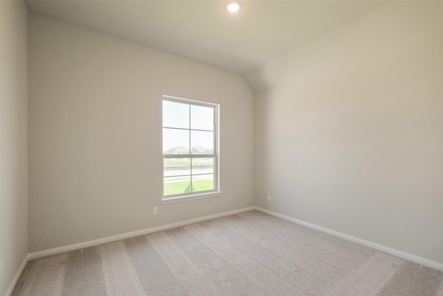 empty room featuring light carpet, baseboards, and recessed lighting