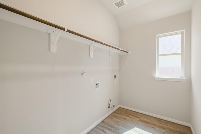 laundry room featuring electric dryer hookup, laundry area, light wood finished floors, gas dryer hookup, and visible vents