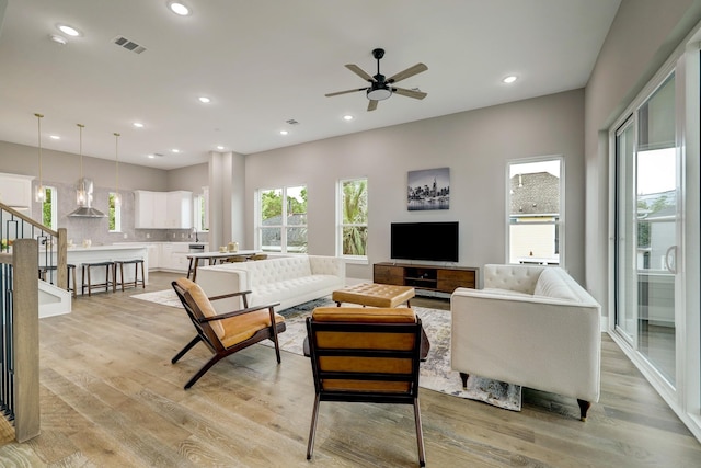 1411 W 23rd St, Houston, TX 77008 - living area with light wood finished floors, a ceiling fan, recessed lighting, and stairway