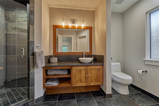 bathroom with a shower stall, visible vents, toilet, vanity, and baseboards
