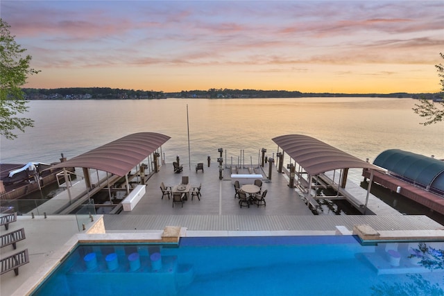 view of swimming pool featuring a boat dock, boat lift, and a water view