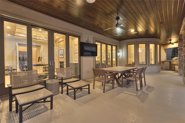 view of patio with outdoor dining area, a ceiling fan, and french doors