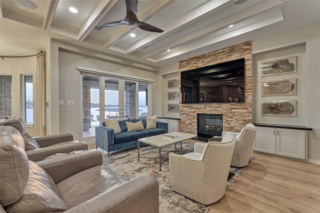 living area featuring recessed lighting, beamed ceiling, light wood-style floors, a fireplace, and ceiling fan