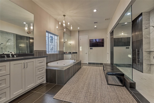 full bathroom featuring a garden tub, tile patterned floors, vanity, a notable chandelier, and recessed lighting