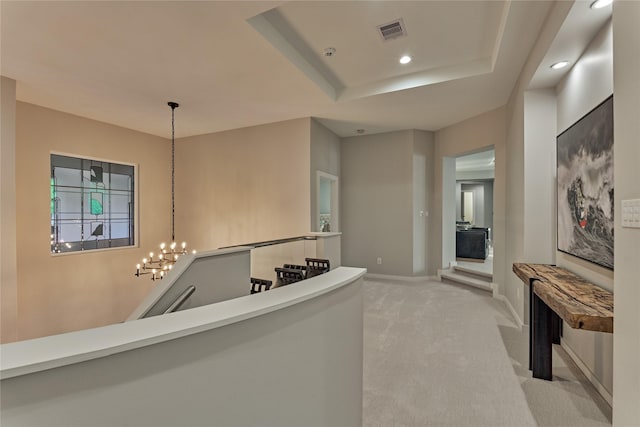 hallway featuring baseboards, recessed lighting, visible vents, carpet, and a chandelier