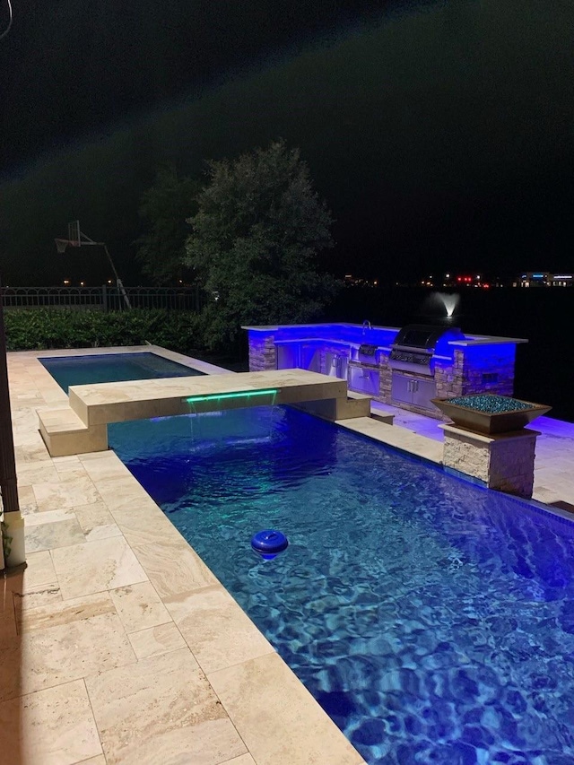 pool at twilight with a patio, a fenced in pool, area for grilling, an in ground hot tub, and fence