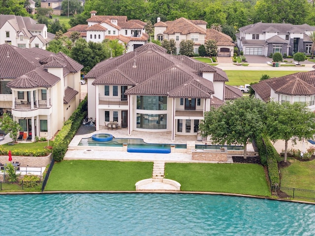 view of swimming pool featuring a fenced backyard, a residential view, a yard, and a patio area