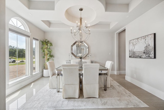 dining room with a wealth of natural light, coffered ceiling, a notable chandelier, and baseboards