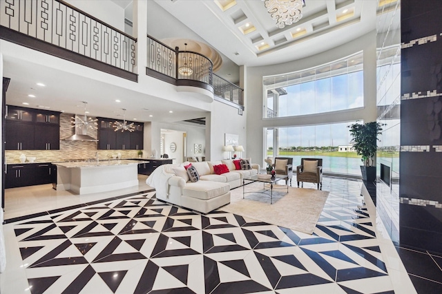living room featuring recessed lighting, a high ceiling, and an inviting chandelier