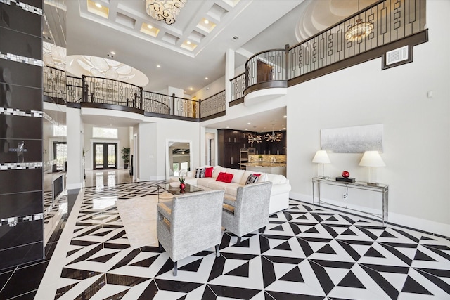 living area with coffered ceiling, recessed lighting, a high ceiling, and baseboards