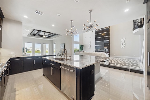 kitchen featuring a sink, a chandelier, open floor plan, recessed lighting, and an island with sink