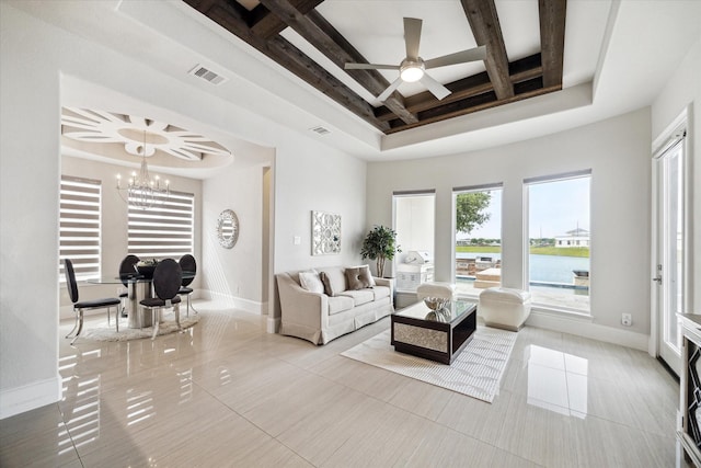 tiled living area featuring baseboards, visible vents, a raised ceiling, and beam ceiling