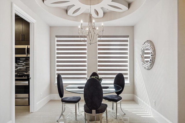 dining space with baseboards and an inviting chandelier