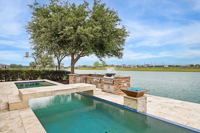 view of pool featuring exterior kitchen, a water view, an in ground hot tub, and a sink