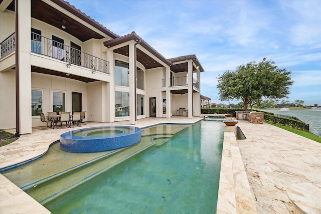 view of pool featuring a patio and a pool with connected hot tub