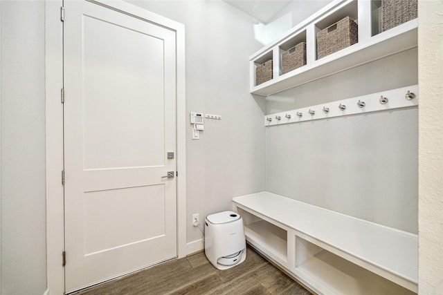 mudroom with wood finished floors and baseboards