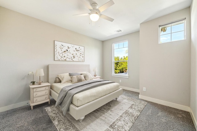carpeted bedroom featuring visible vents, ceiling fan, and baseboards