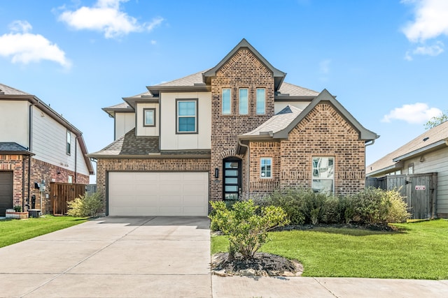 view of front of property featuring concrete driveway, fence, and a shingled roof