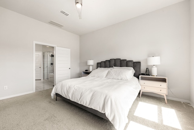 bedroom featuring visible vents, baseboards, light carpet, and connected bathroom